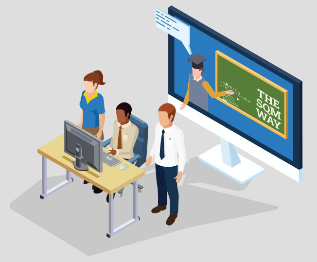 a fwe people behind a computer talking with a larger monitor behind with a grad pointing at a chalkboard