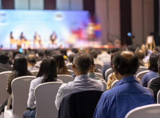 an audience viewing a presentation on a stage